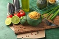 Board with quinoa stuffed zucchini on green table