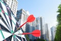 Board with red darts hitting target against blurred of view cityscape Royalty Free Stock Photo