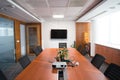 Board room in a modern office with wooden table, white board and teelvision screen