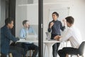 Multi-ethic business people listens indian woman coach giving presentation