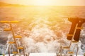 On-board the ship on the background ship trail waves and sunset. Royalty Free Stock Photo