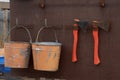 Board with a shovel, fire extinguishers, buckets and axes on construction site.