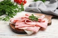 Board with sliced raw bacon on wooden table Royalty Free Stock Photo