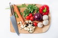 Board with sliced vegetables, carrots, mushrooms, parsley, pepper, eggplant, onion. Raw vegetarian healthy food Royalty Free Stock Photo