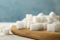 Board with sugar cubes on background, close up Royalty Free Stock Photo