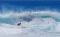 Board surfer riding a wave at Aliso Beach in Laguna Beach, California.