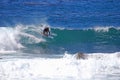 Board surfer riding in a wave at Laguna Beach, CA.