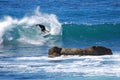 Board surfer riding in a wave at Laguna Beach, CA.