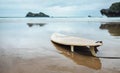 Board for surfing on deserted ocean beach Royalty Free Stock Photo