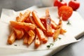 Board with sweet potato fries on grey table Royalty Free Stock Photo