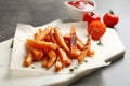 Board with sweet potato fries on grey table Royalty Free Stock Photo