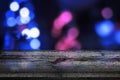 Board, table for product presentation. Blue bokeh city lights in background