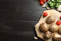 Board with tasty baked jacket potatoes on wooden background, top view.