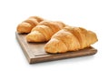 Board with tasty croissants on white background Royalty Free Stock Photo