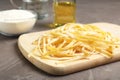 Board with uncooked egg noodles on grey table, Royalty Free Stock Photo