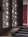 Board wall cutting or drilled out in minimal style flowers shape as natural lighting source