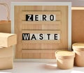 A board with the words Zero waste. A cardboard box. Paper packaging for food products. Recyclable paper. Royalty Free Stock Photo