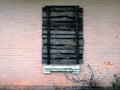 Boarded up old window on the pink wall of the building Royalty Free Stock Photo