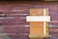 Boarded up window on wooden wall of abandoned house Royalty Free Stock Photo