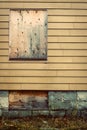 Boarded up windows in abandoned house