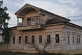 Boarded up windows on the old wooden wall of the house. Carving adorns the old window. The walls of the house from the Royalty Free Stock Photo