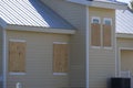 Boarded up windows with plywood storm shutters for hurricane protection of residential house. Protective measures before Royalty Free Stock Photo