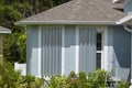 Boarded up windows with steel storm shutters for hurricane protection of residential house. Protective measures before Royalty Free Stock Photo