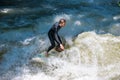 Boarders surfing on the Isar river in Munich, Bayern, Germany