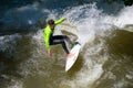 Boarders surfing on the Isar river in Munich, Bayern, Germany