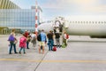 Boarding passengers on the plane. People with luggage go up the stairs to the aircraft cabin. Passenger plane. Travel