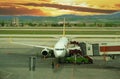 Boarding Pegasus airlines plane with ramp on Esenboga airport in Ankara, Turkey at sunset