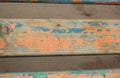 Boards covered with old paint on a natural background. Orange,green, blue cracked paint on old wood Royalty Free Stock Photo