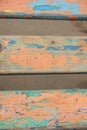 Boards covered with old paint on a natural background. Orange,green, blue cracked paint on old wood Royalty Free Stock Photo