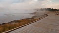 Boardwalk curving around Hot Lake hot spring in the Lower Geyser Basin in Yellowstone National Park in Wyoming USA