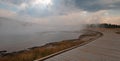 Boardwalk curving around Hot Lake hot spring in the Lower Geyser Basin in Yellowstone National Park in Wyoming USA