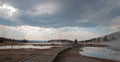 Boardwalk curving between Hot Lake hot spring and Hot Cascades hot spring in Yellowstone National Park USA