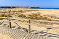 Boardwalk and fence on sandy beach, Tarifa, Spain