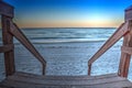 Boardwalk leading down to the white sand of Vanderbilt Beach at sunrise Royalty Free Stock Photo