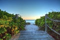 Boardwalk leading down to the white sand of Vanderbilt Beach at sunrise Royalty Free Stock Photo