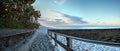 Boardwalk leading down to the white sands along the North Gulf Shore Beach at sunrise Royalty Free Stock Photo