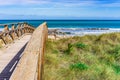 Boardwalk over dunes with marram grass to the beach Royalty Free Stock Photo