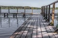 Boardwalk pier and calm water in a rural landscape Royalty Free Stock Photo