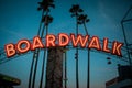 Boardwalk sign with lights and palm trees