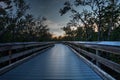 Boardwalk through the swamp, leading to Pass at sunset i Royalty Free Stock Photo