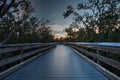 Boardwalk through the swamp, leading to Pass at sunset i Royalty Free Stock Photo