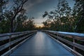 Boardwalk through the swamp, leading to Pass at sunset i Royalty Free Stock Photo