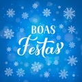 Boas Festas calligraphy isolated on blue background with bokeh and snowflakes. Happy Holidays lettering in Portuguese. Christmas Royalty Free Stock Photo