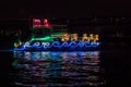 Boat Adorned with Christmas Holiday Lights, Santa Claus Sleigh and Reindeer and Reflection in the Water. Royalty Free Stock Photo