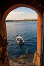 Boat in the Adriatic sea as seen from arched wall in Rovinj at sunset, Istrian Peninsula, Croatia