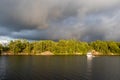 One boat anchored in a calm bay on a cloudy evening as the sun sets Royalty Free Stock Photo